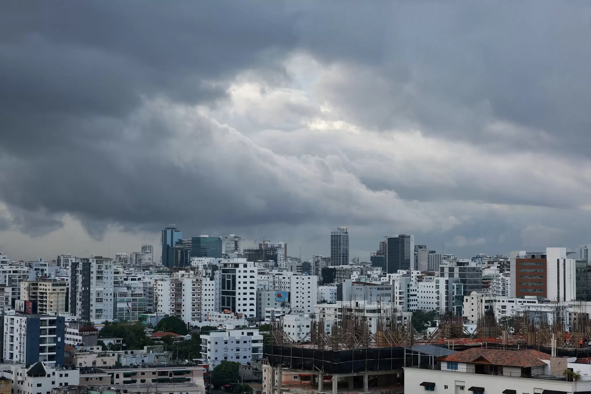Dark storm clouds are pictured over apartment buildings in Santo Domingo, Dominican Republic