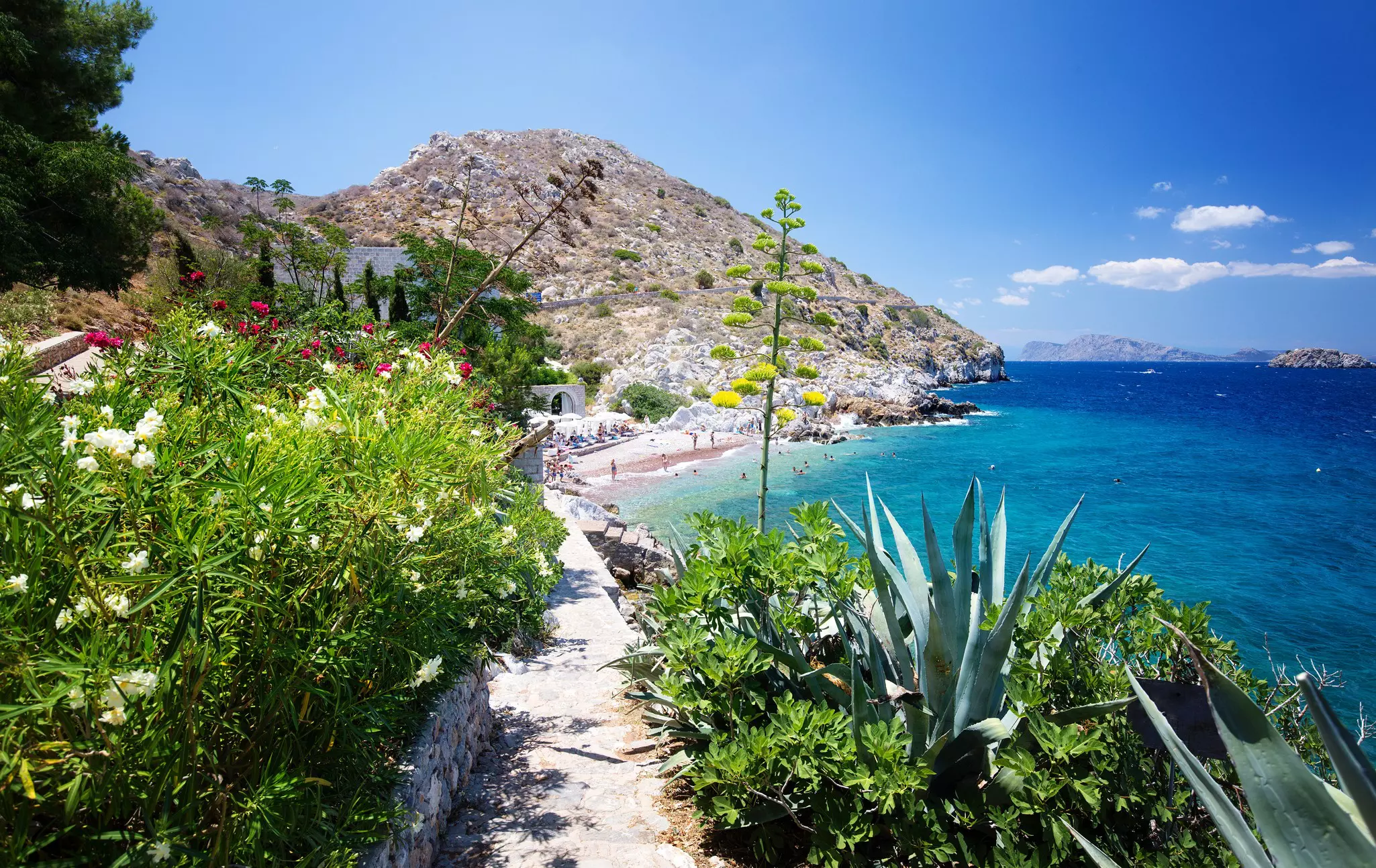View from Hydra Island. Castello Hydra and Kamini beach. Blue sky, License Type: media, Download Time: 2025-09-22T19:40:19.000Z, User: bhealy950, Editorial: false, purchase_order: 65050 - Digital Destinations and Articles, job: Lonely Planet Online Editorial, client: Best things to do in Hydra, other: Brian Healy