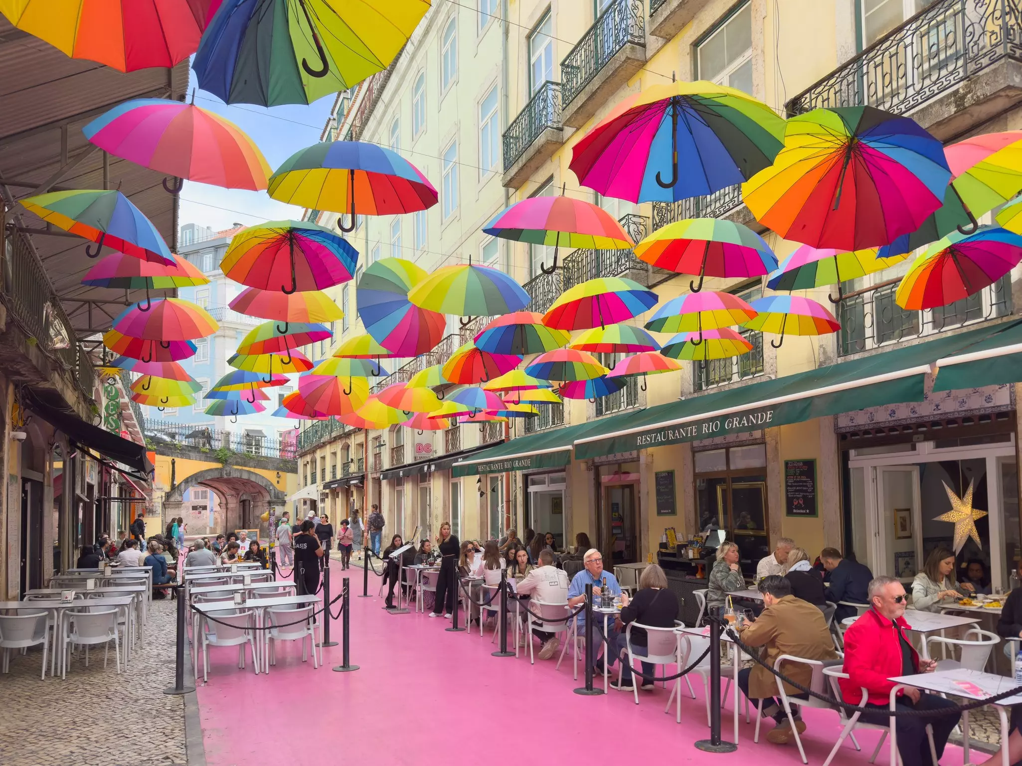 Colorful umbrellas above Rua Cor-de-Rosa in Lisbon