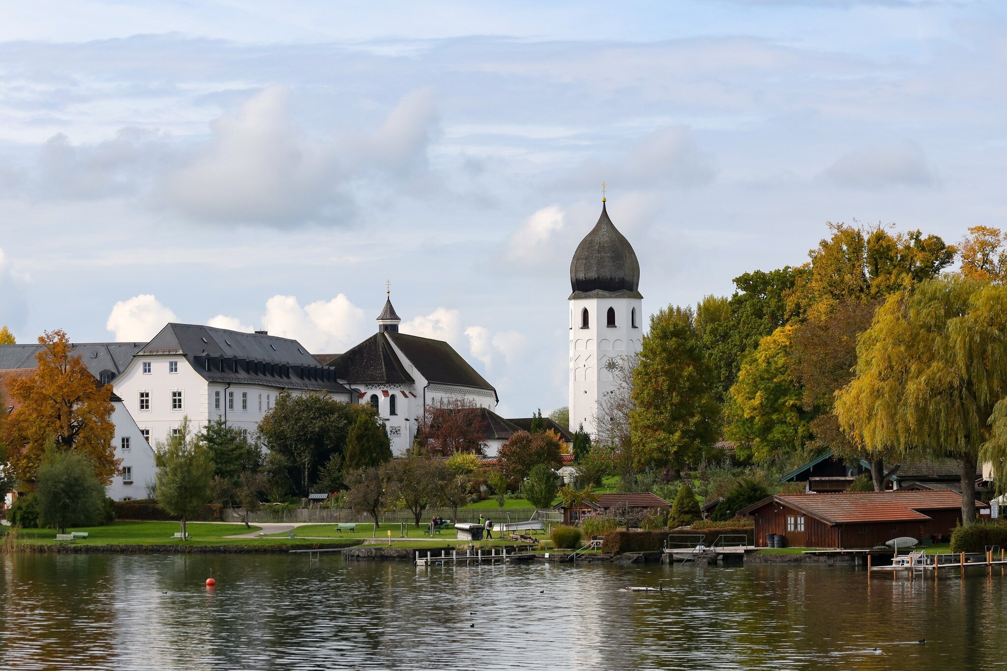 The Frauenwörth Abbey with its jetty in autumn on the Chiemsee, Germany.