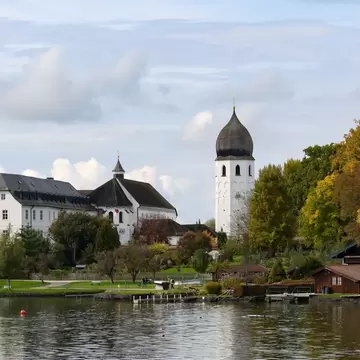 The Frauenwörth Abbey with its jetty in autumn on the Chiemsee, Germany.