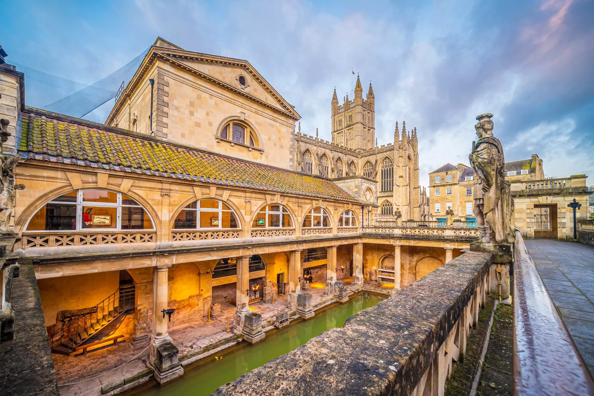 Historical roman bathes in Bath city, England at twilight.