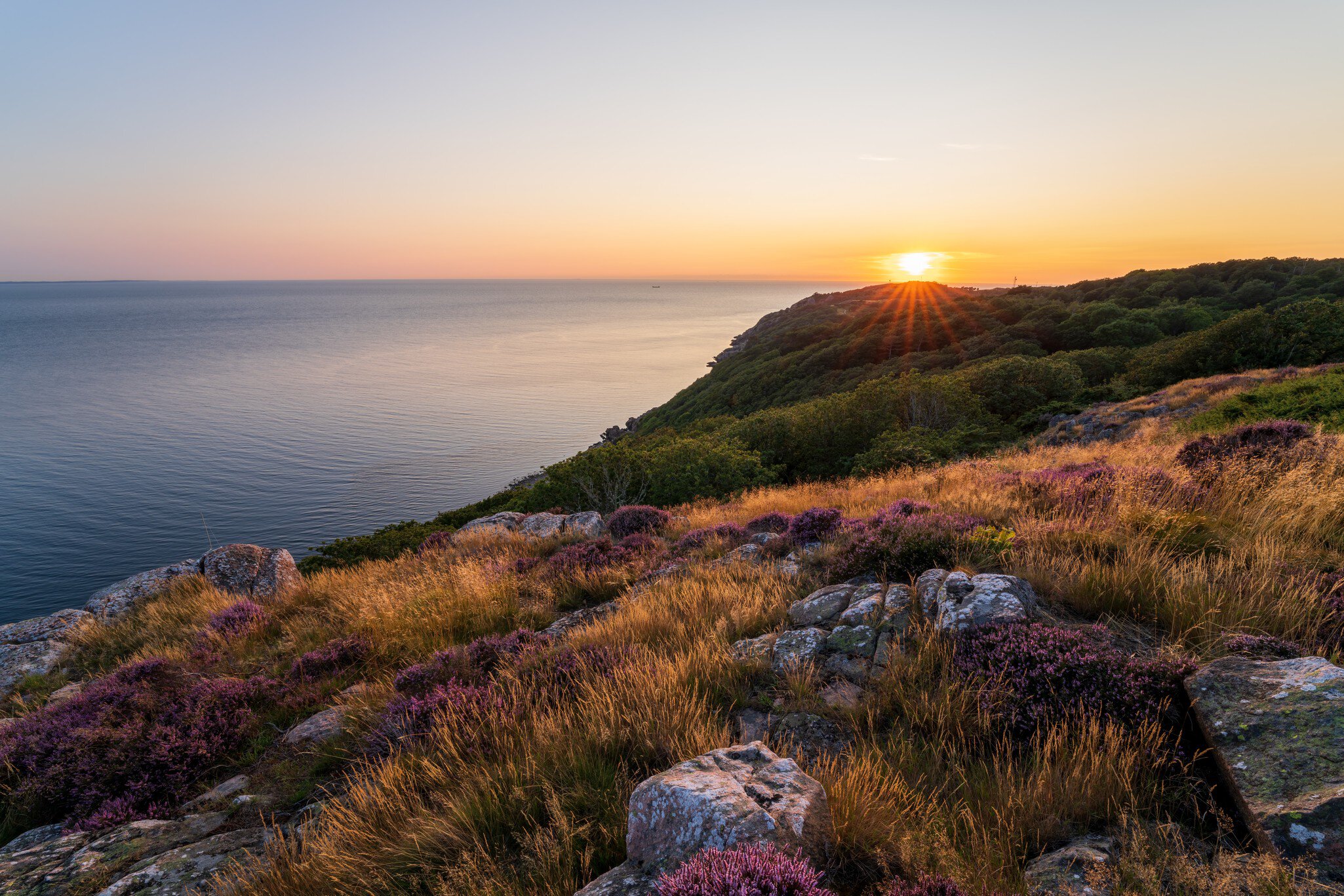 Gorgeous summer sunset from top of mountain at Kullaberg nature reserve in southern Sweden.; Shutterstock ID 2029759976; your: Kristen Parker; gl: 65050; netsuite: digital download; full: POIs