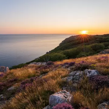 Gorgeous summer sunset from top of mountain at Kullaberg nature reserve in southern Sweden.; Shutterstock ID 2029759976; your: Kristen Parker; gl: 65050; netsuite: digital download; full: POIs