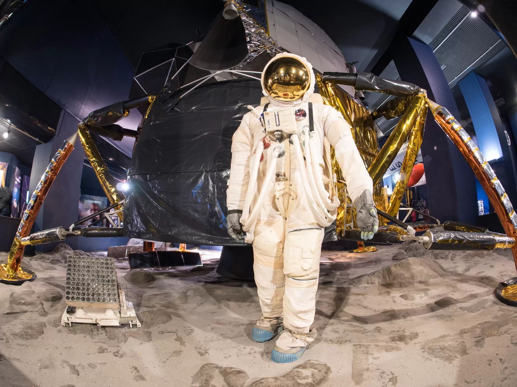 A spacesuit and landing module that are part of the space exhibition at the London Science Museum. 