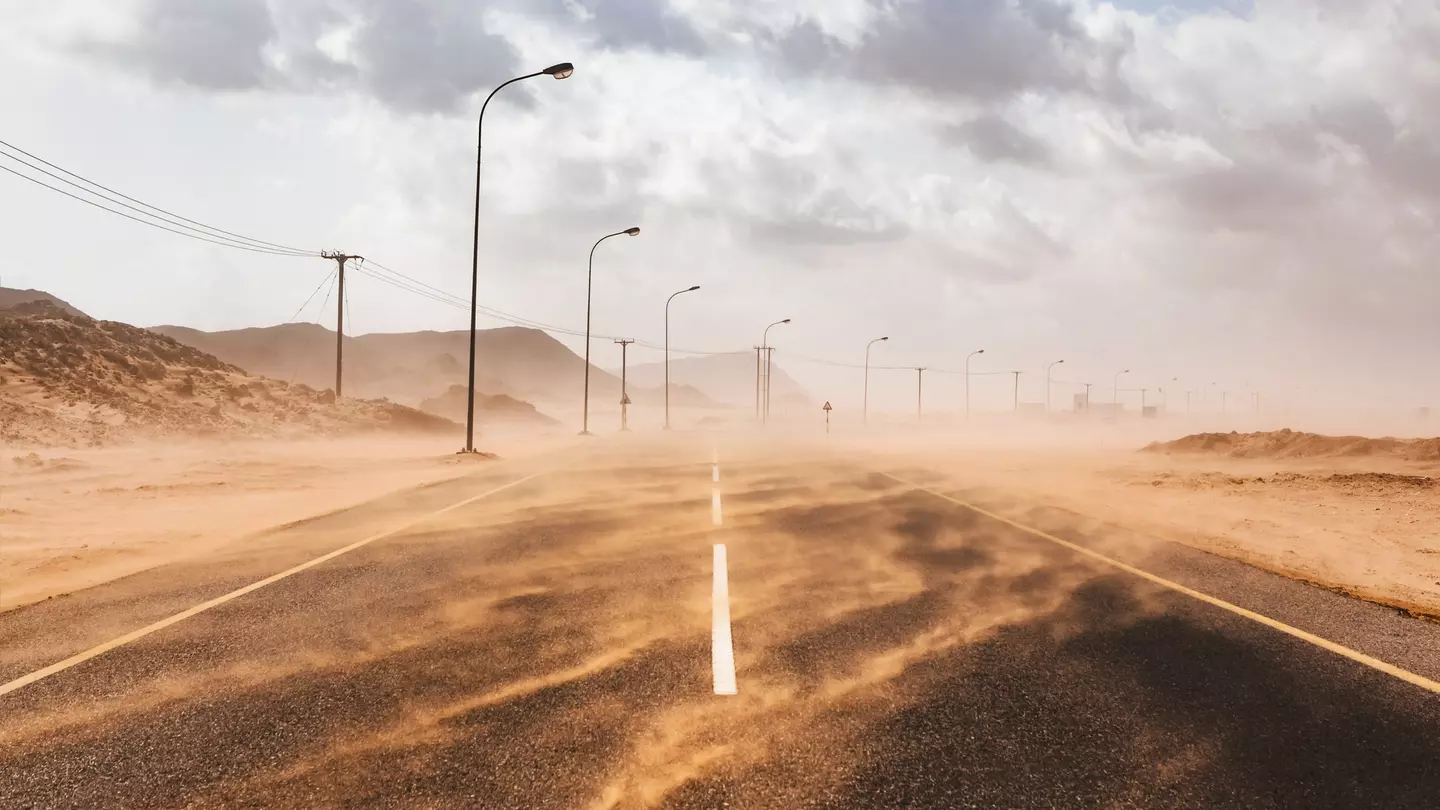 Sand blows across a road during a sandstorm in Ras al Hadd, Oman