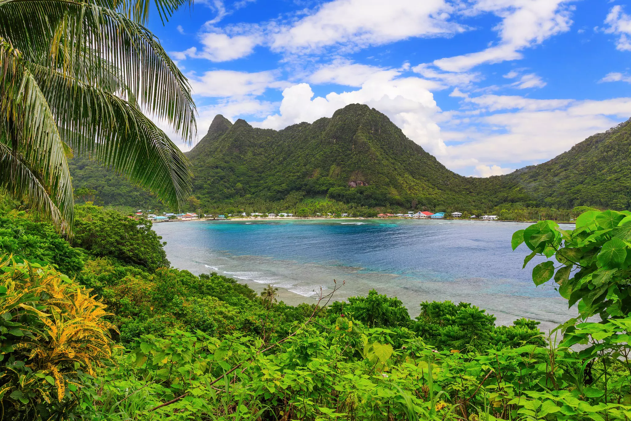 A cove surrounded by steep hills covered with greenery.