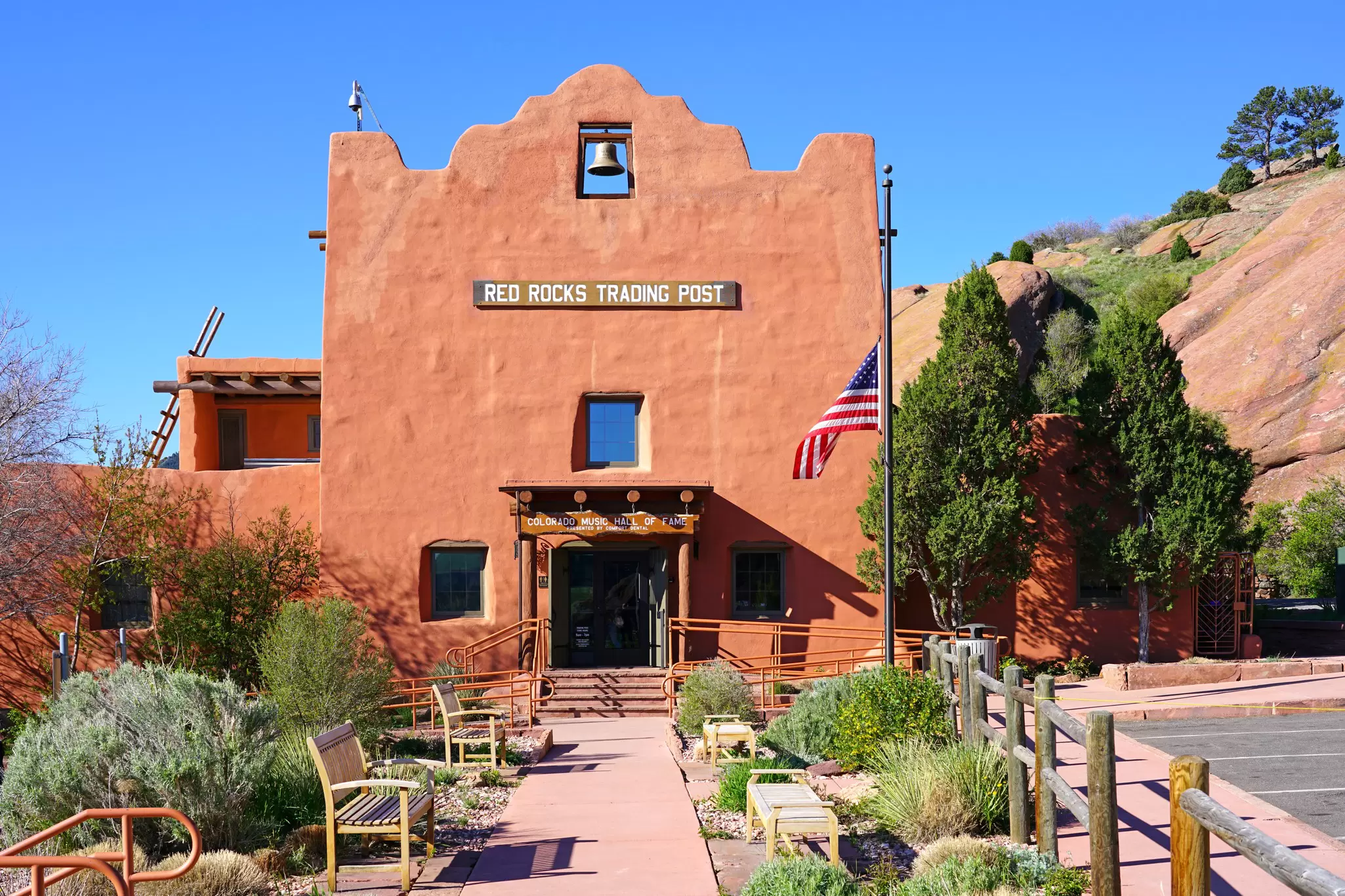 An adobe building with an American flag at half-staff.