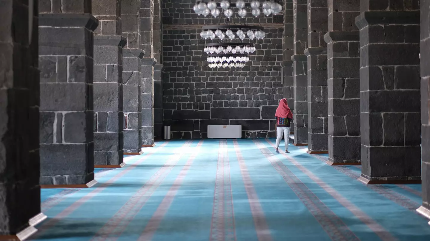 Woman explores the interior of Diyarbakır's Great Mosque, Turkey