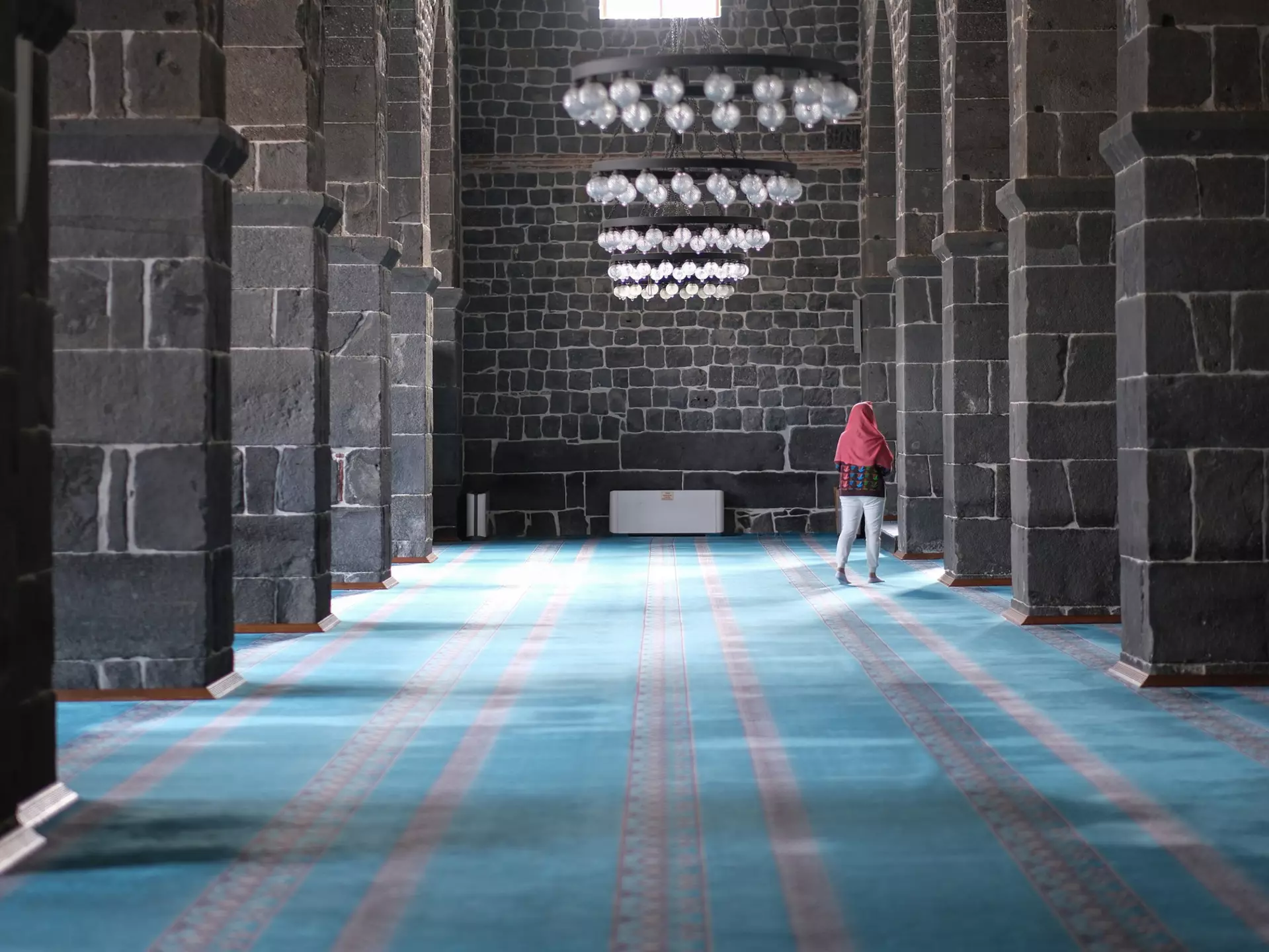 Woman explores the interior of Diyarbakır's Great Mosque, Turkey