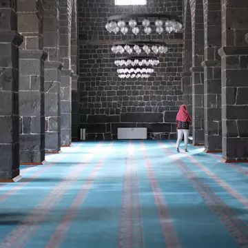Woman explores the interior of Diyarbakır's Great Mosque, Turkey
