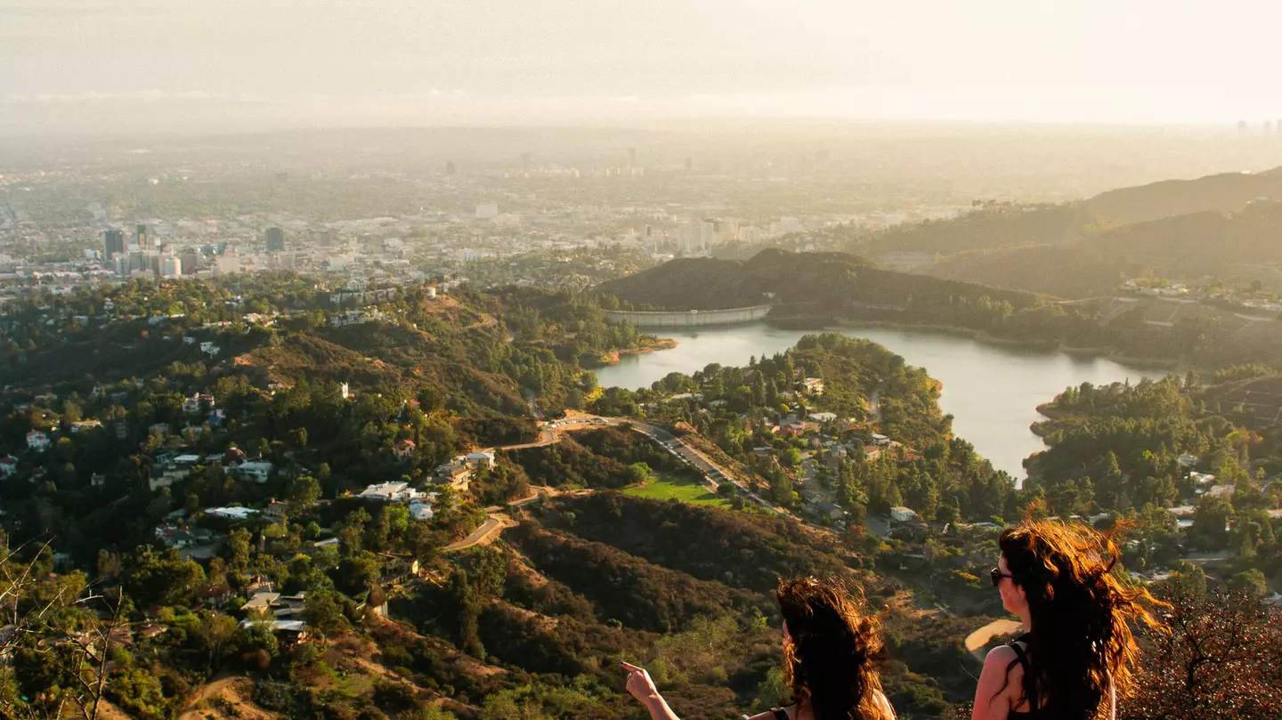 Two woman looking out over the Los Angeles skyline.