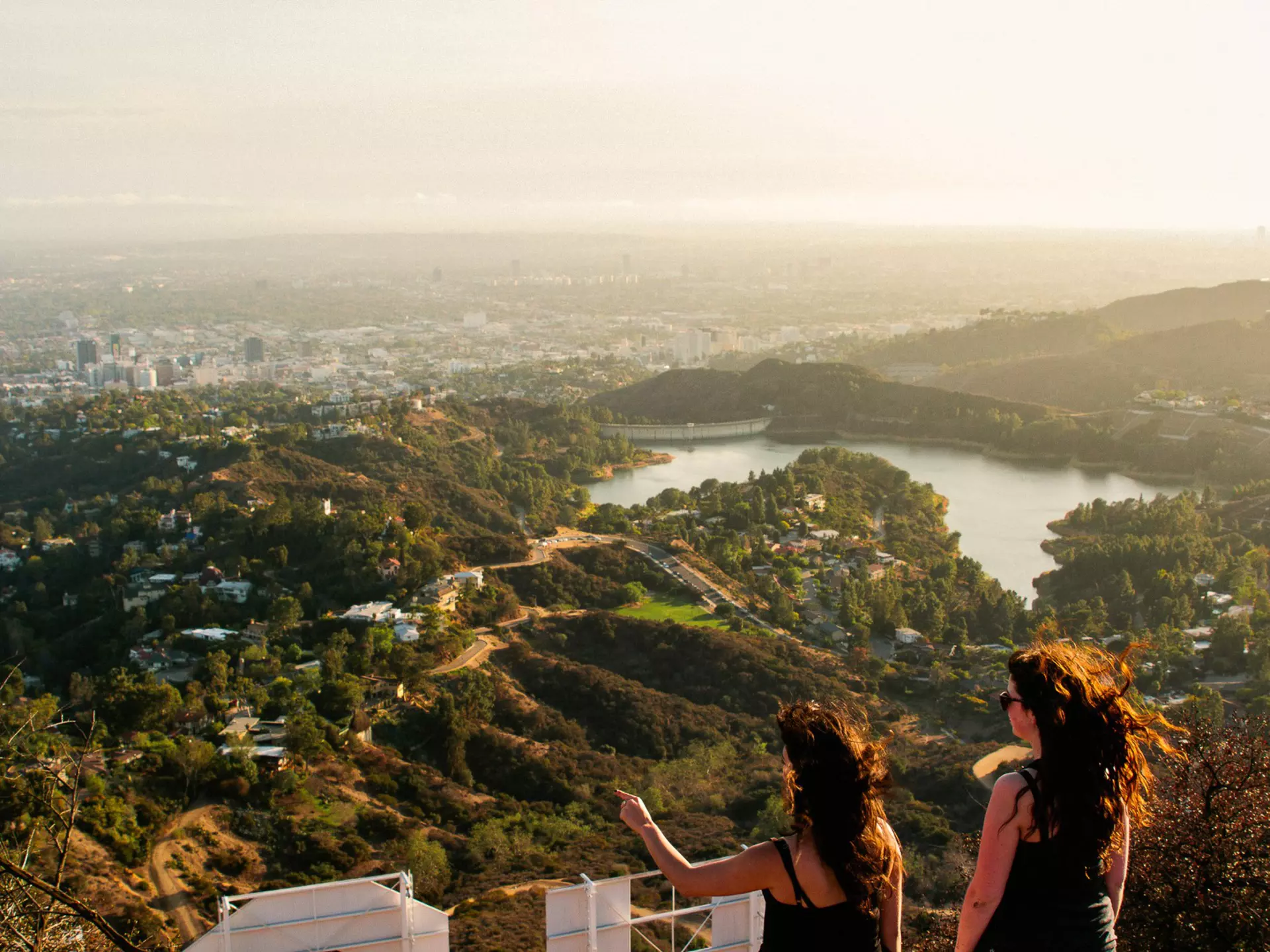 Two woman looking out over the Los Angeles skyline.
