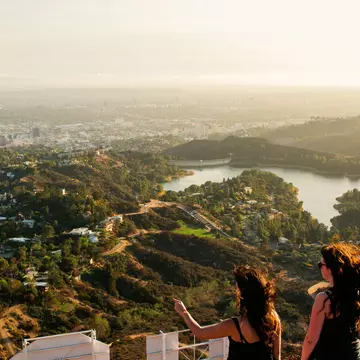 Two woman looking out over the Los Angeles skyline.
