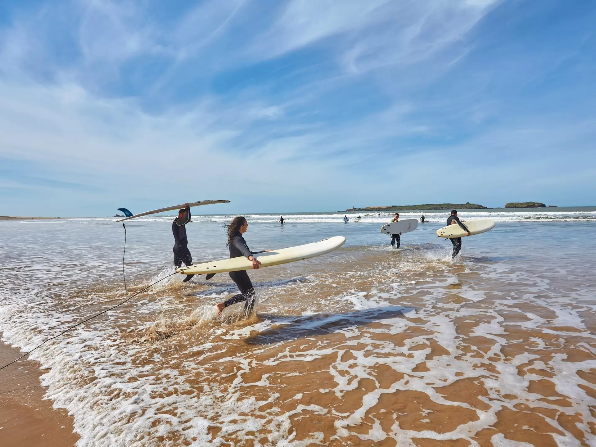 Surf beginners learning the ropes in the gentle waves of Essaouira. Ryzhkov Oleksandr/Shutterstock