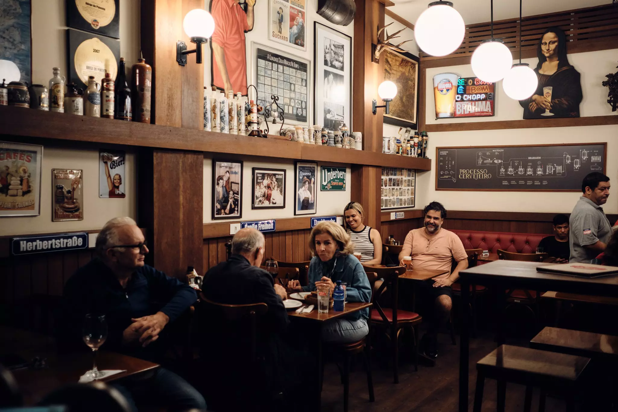 Interior of a restaurant with people sitting inside and memorabilia on the walls. 