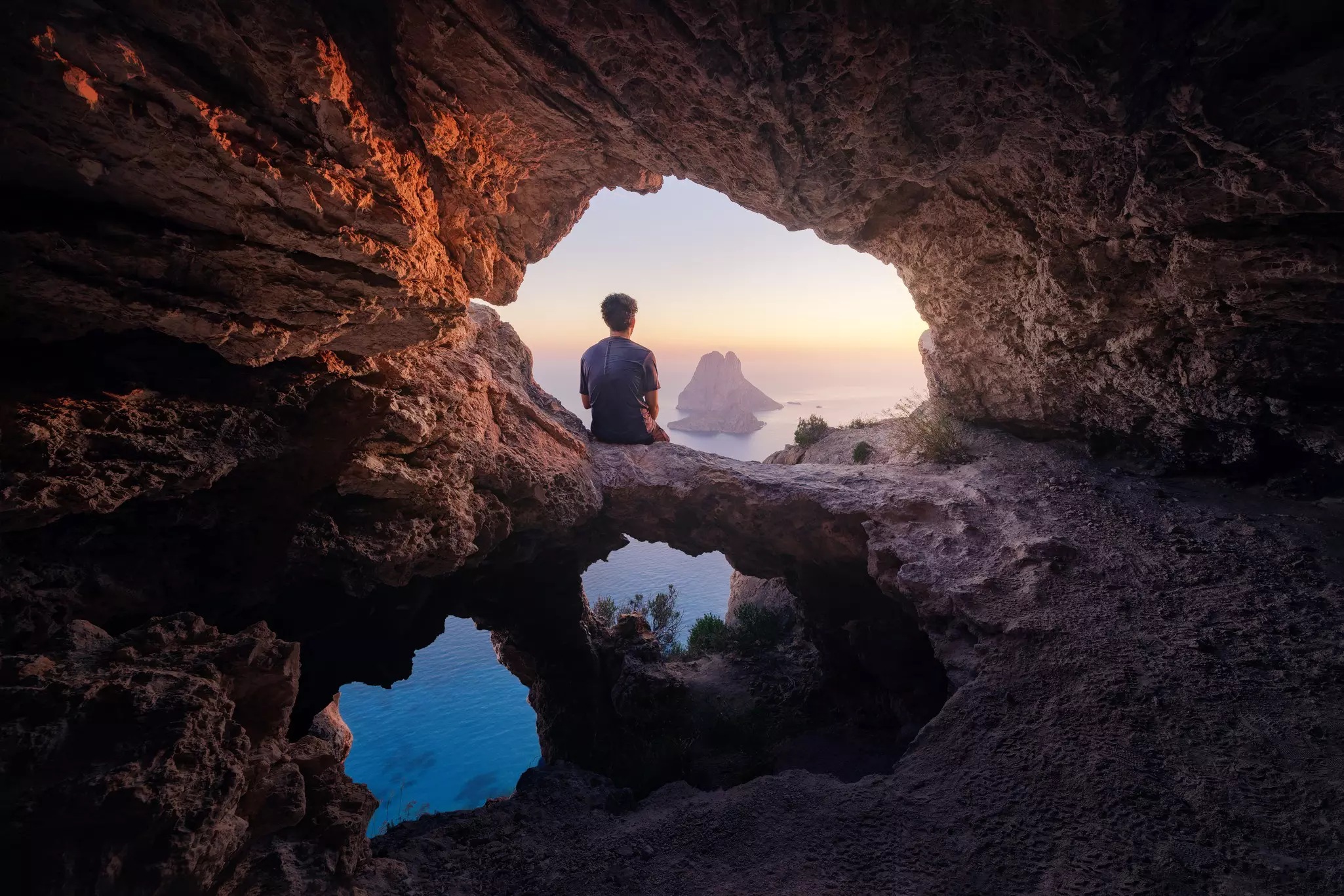 Enjoying the sunset from a cave on the island of Es Vedra near San Antonio © Daniel Garrido / Getty Images