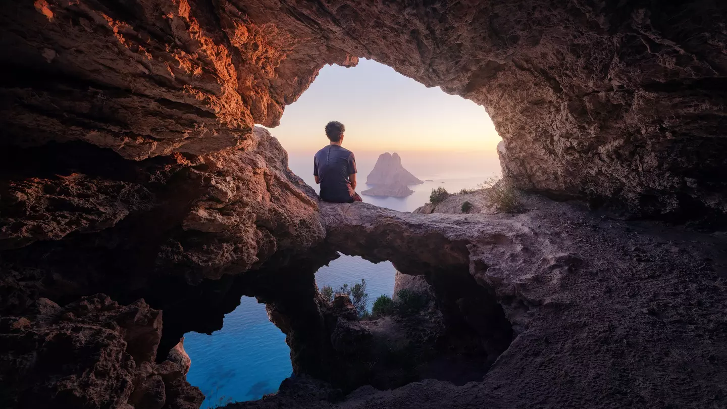 Enjoying the sunset from a cave on the island of Es Vedra near San Antonio © Daniel Garrido / Getty Images