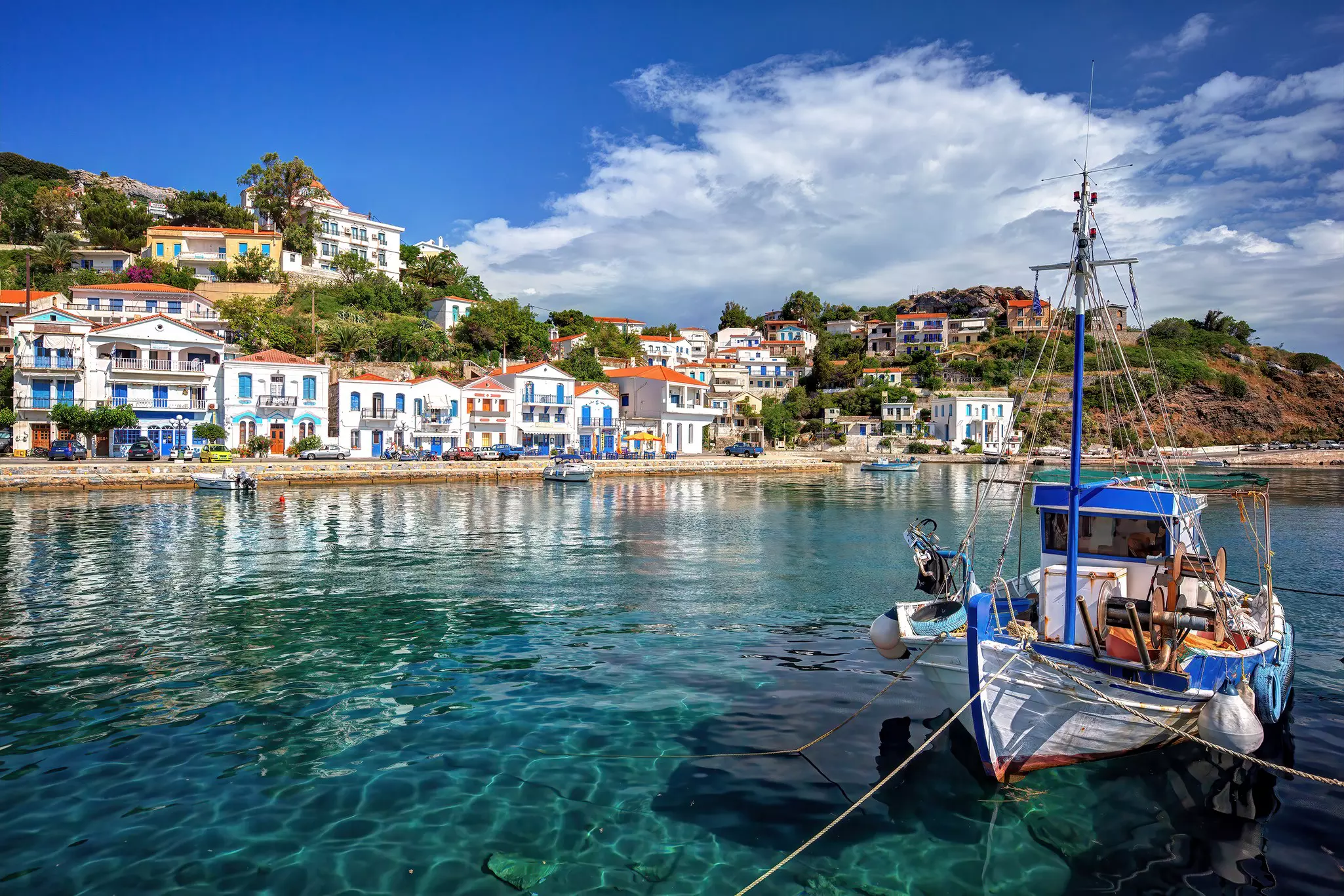 A boat moored in the harbor of the village of Evdilos on the island of Ikaria. 