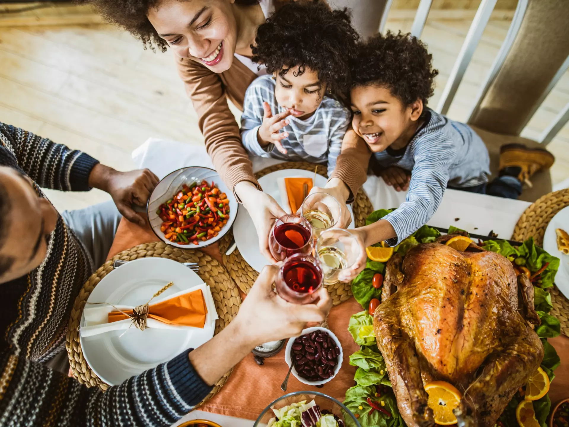 High angle view of happy African American family toasting during Thanksgiving lunch at dining table.
1151543628