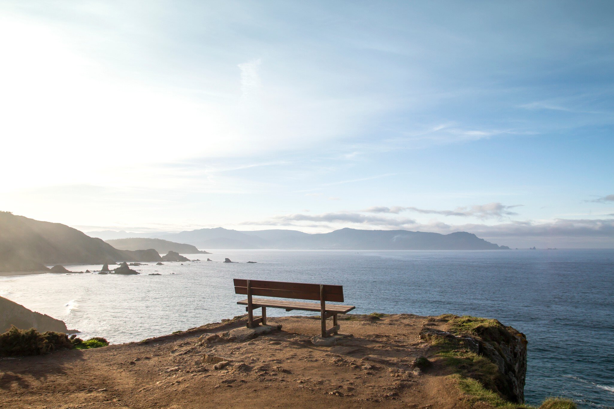 View of a wooden bench, known as the Best Bank of the World (Banco de Loiba), with a stunning view of the sea in Galicia, Spain.
