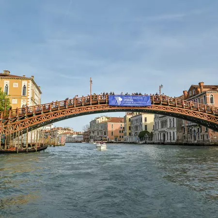 Crowd of tourists standing on Ponte dell Accademia on Canal Grande in city of Venice, Italy during April 2019, 