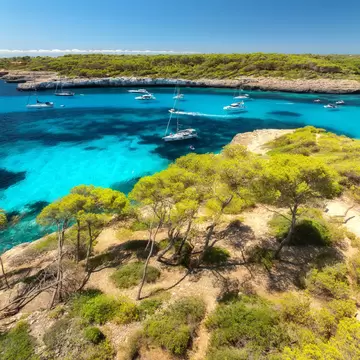 View of boats in the water by Cala Mondragó on the island of Mallorca, Spain.