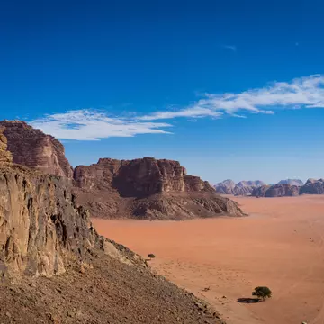 View from Jebel Rum in wadi rum desert, camp from view, Rock mountains in Jordan, lonely tree in the desert; Shutterstock ID 1612550701;