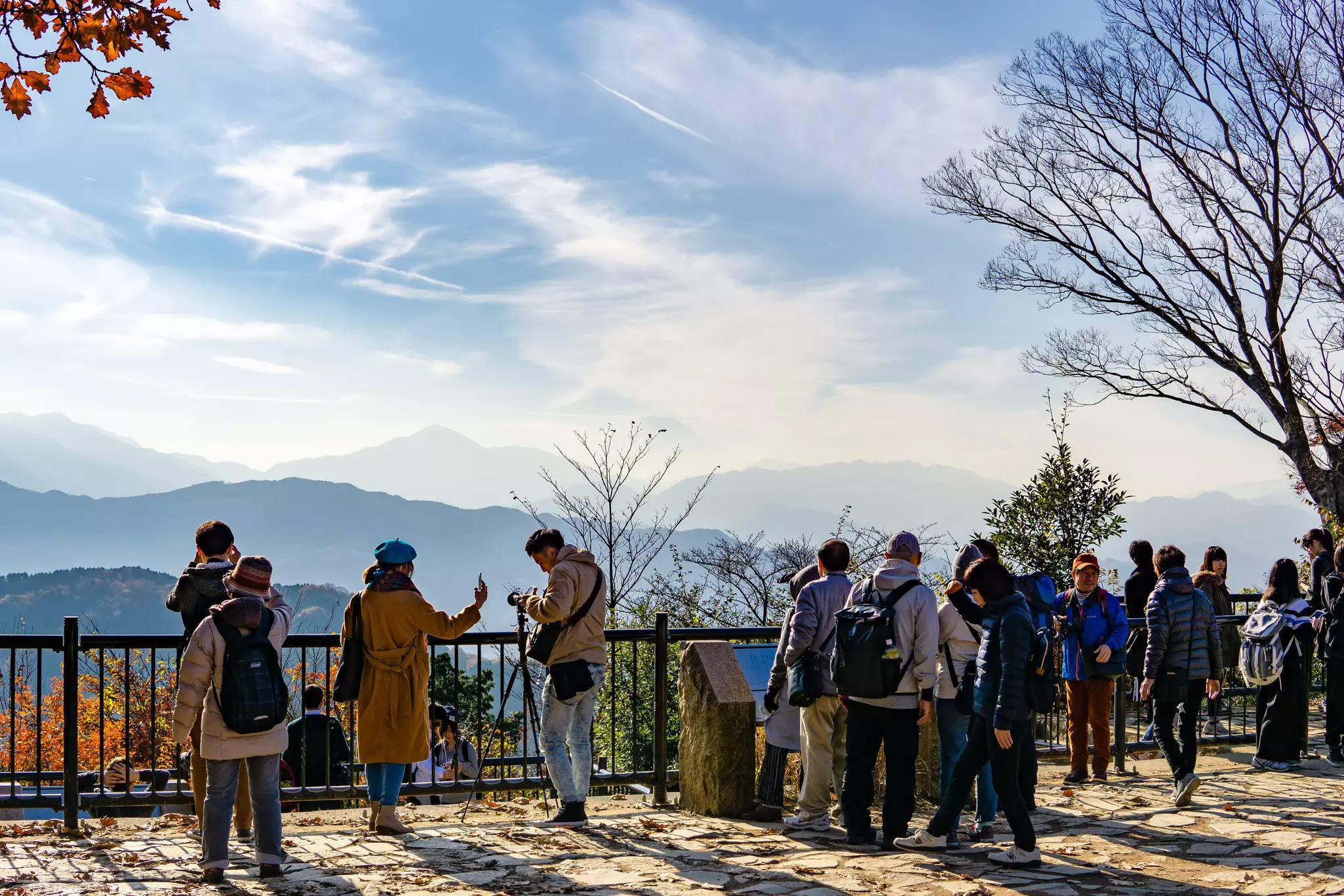 A crowd gathers at a Mount Fuji lookout point at the top of Mount Takao (Takao-San).