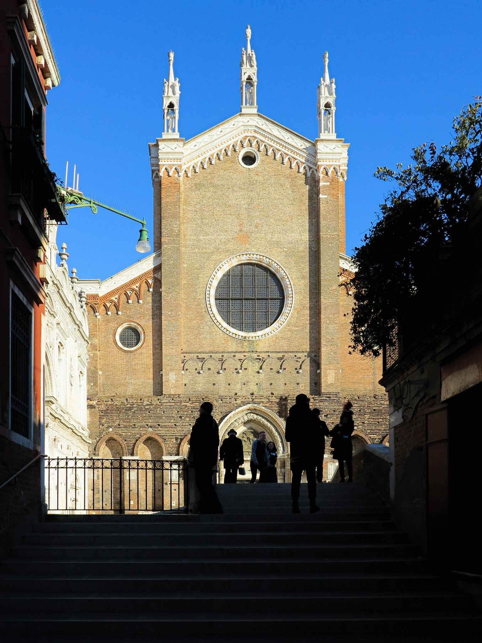 Silhouettes in front of the Basilica dei Santi Giovanni e Paolo, known in Venetian as San Zanipolo, a church in Venice, Italy.