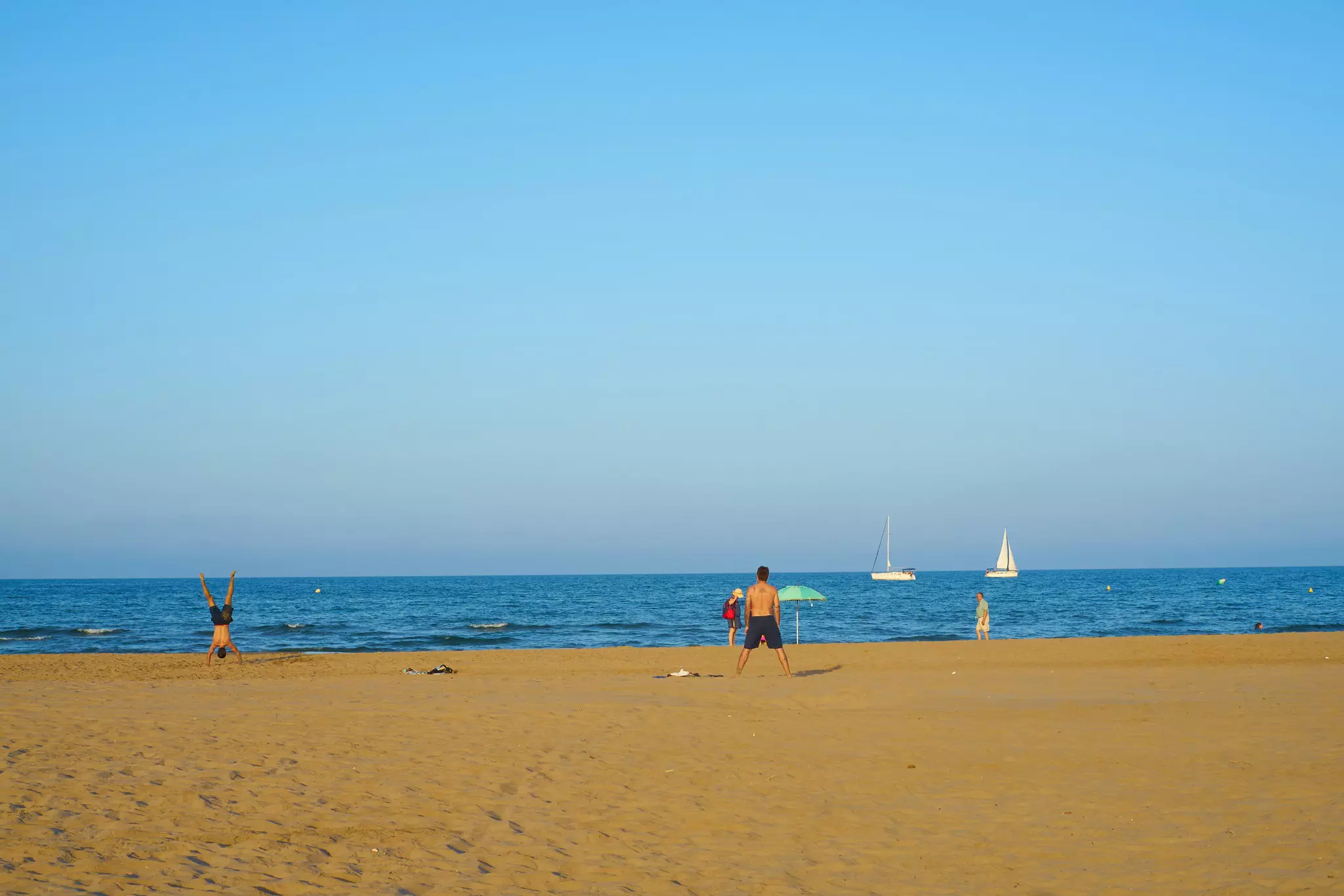 A family play on a sandy beach
