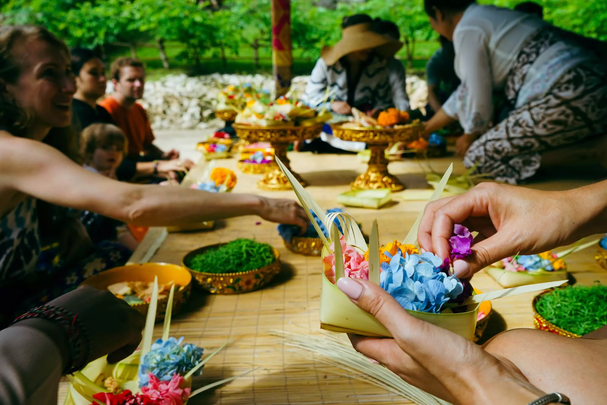 Guests make canang sari offerings at the Four Seasons Resort in Bali, Indonesia.