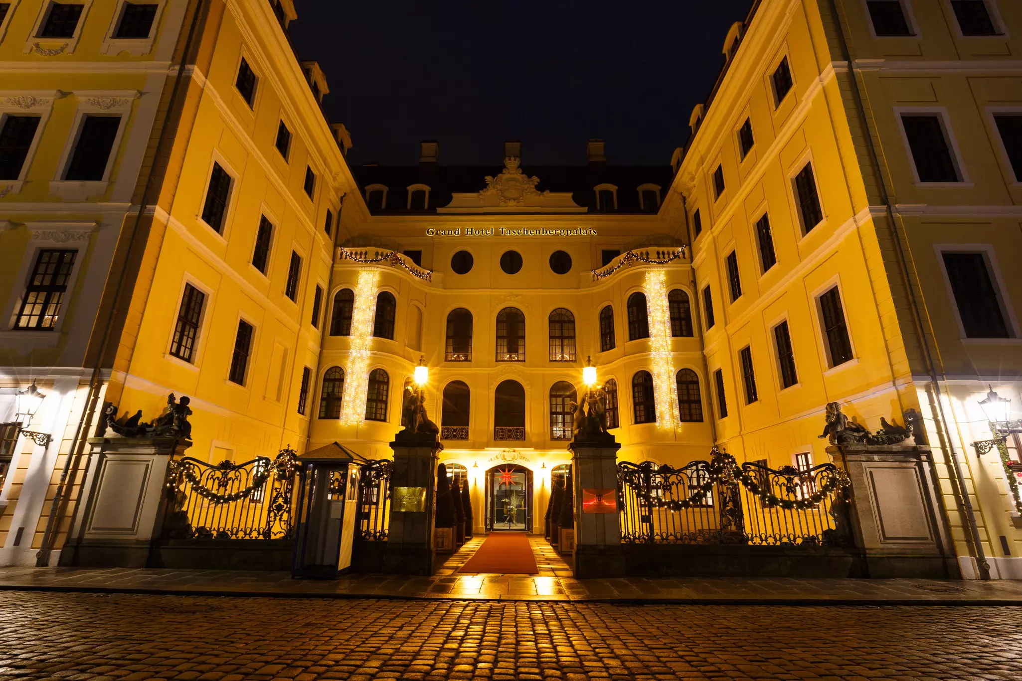 The exterior of a grand hotel lit up at night