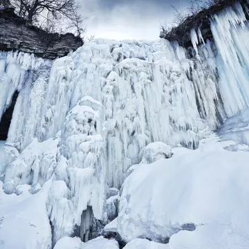 A bike rider climbing up the frozen Minnehaha waterfall in Minneapolis