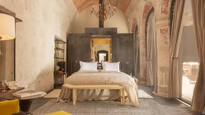 A bedroom in a luxury hotel.