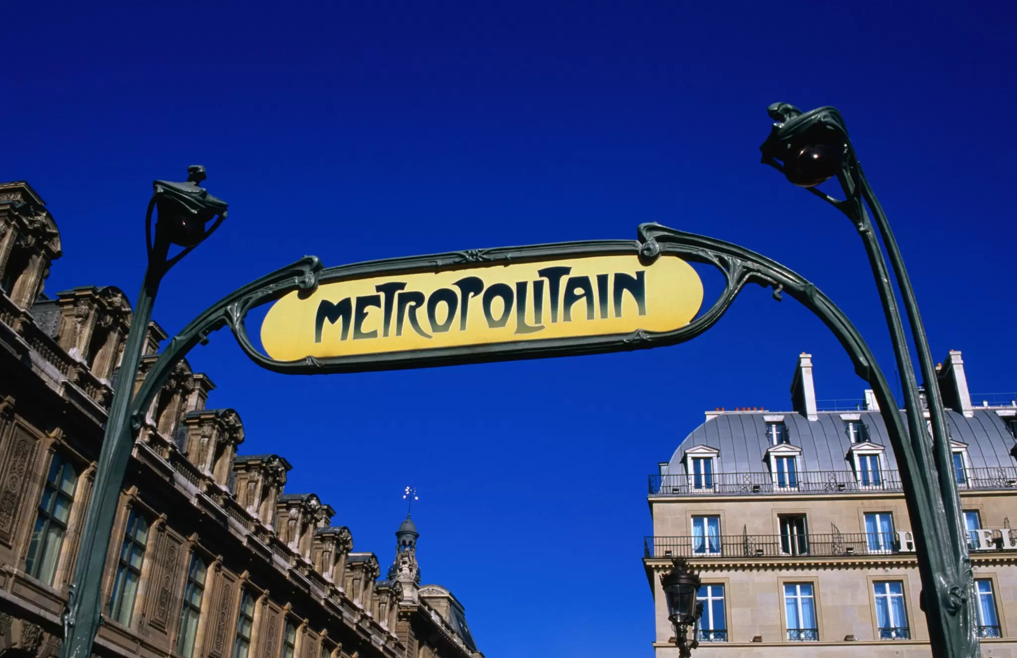 A decorative sign reading "Metropolitan" under blue sky.