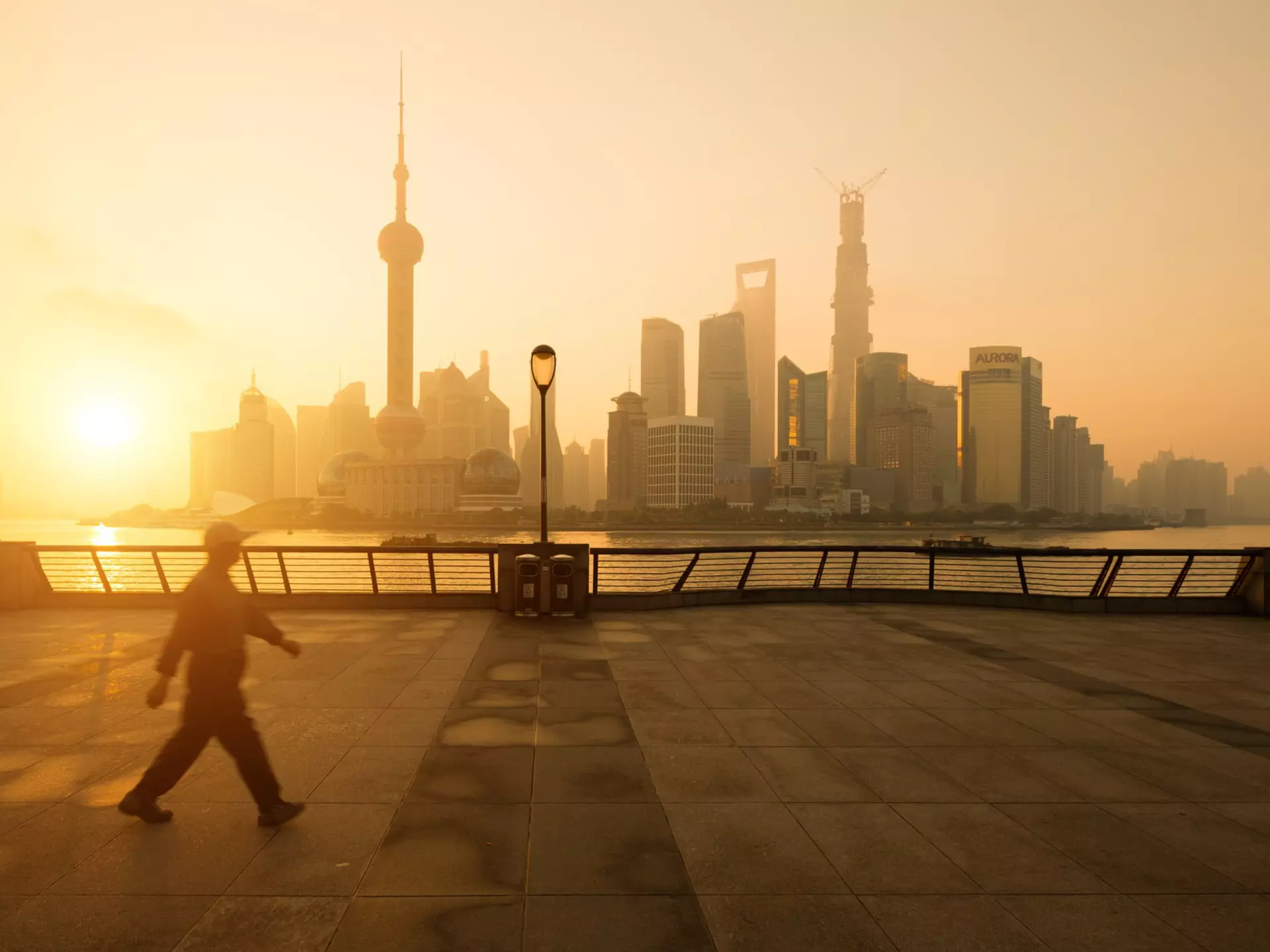 A stroll along the Bund at sunrise offers a great view across the Huangpu River to the skyscrapers of Shanghai's Pudong district. Spreephoto.De / Getty Images