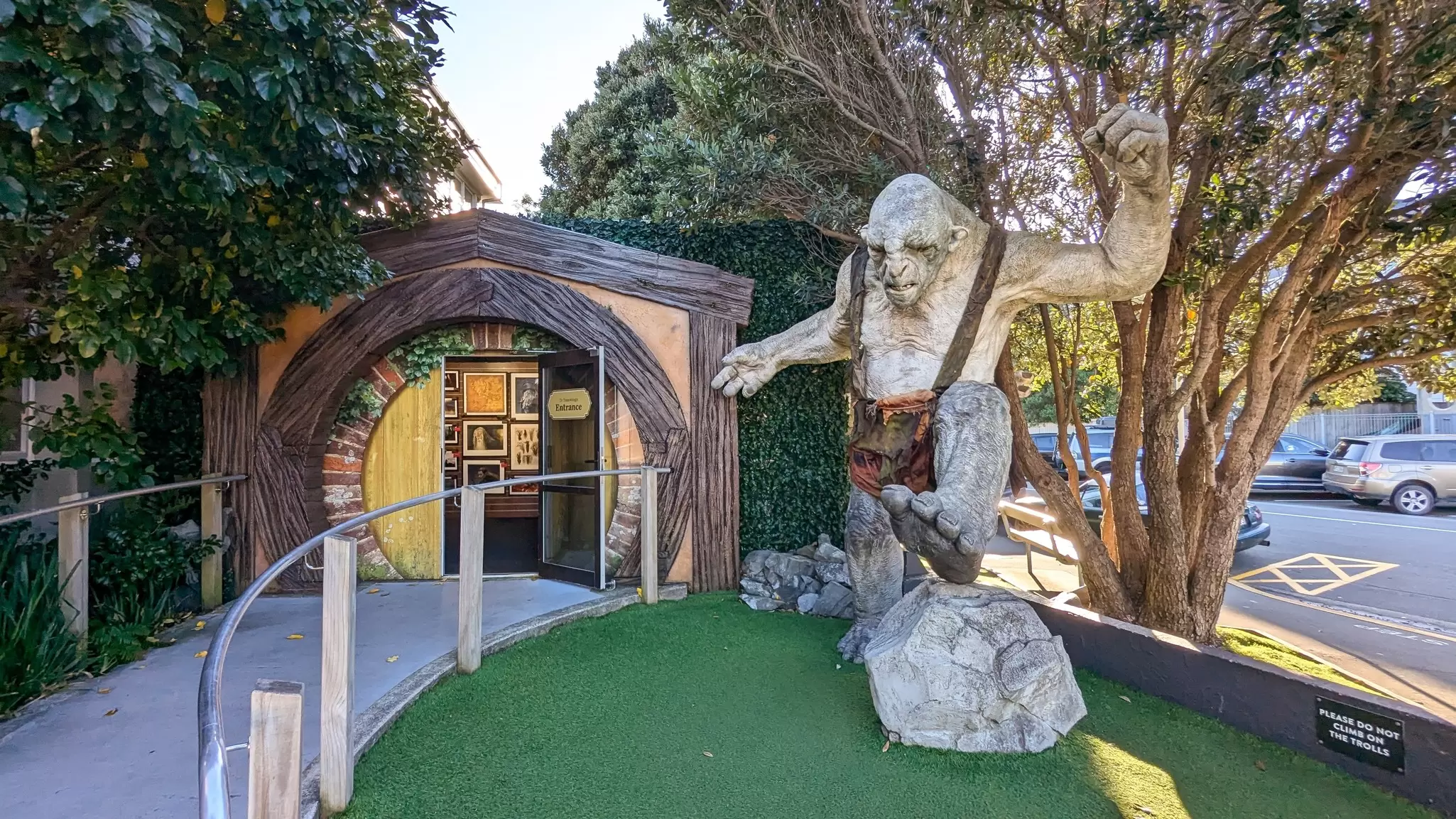 Exterior view of popular tourism attraction of Weta Cave shop and museum with the Hobbit Door and a troll from The Lord of the Rings in Miramar.