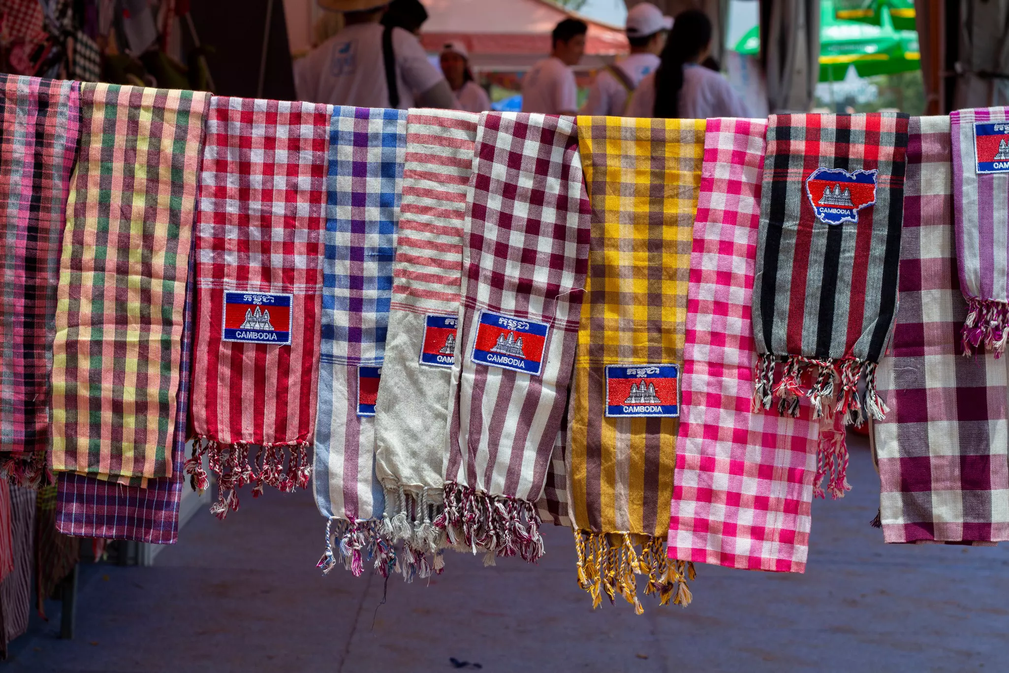 Checked scarves in many color combinations on sale at a souvenir market in Cambodia.