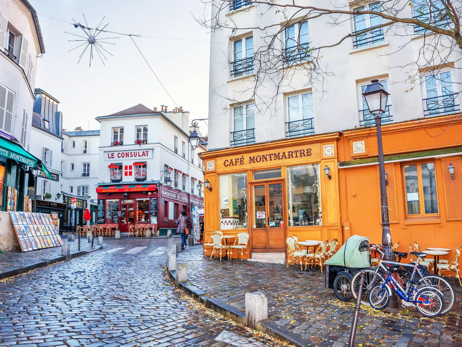 A French street in the Montmartre district with small cafes, restaurants and art galleries.