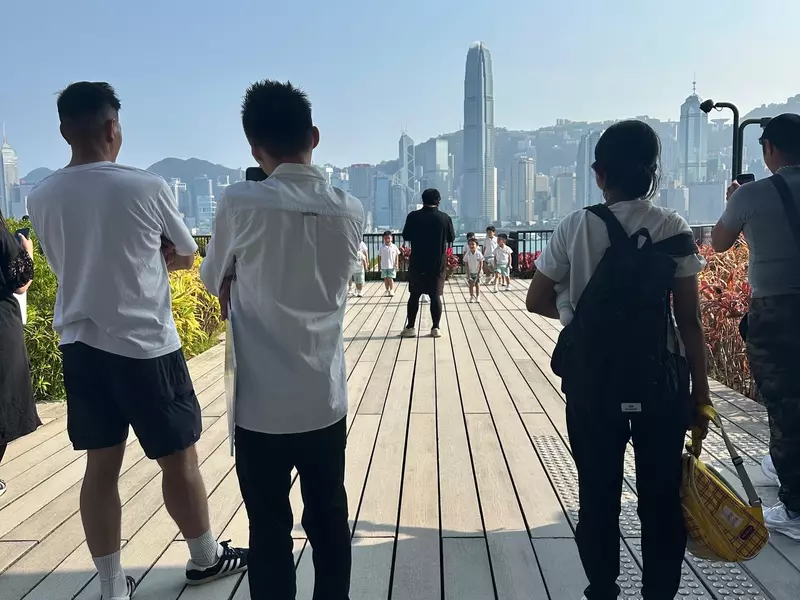 People gathered on the outdoor terrace of the M+ museum in Hong Kong