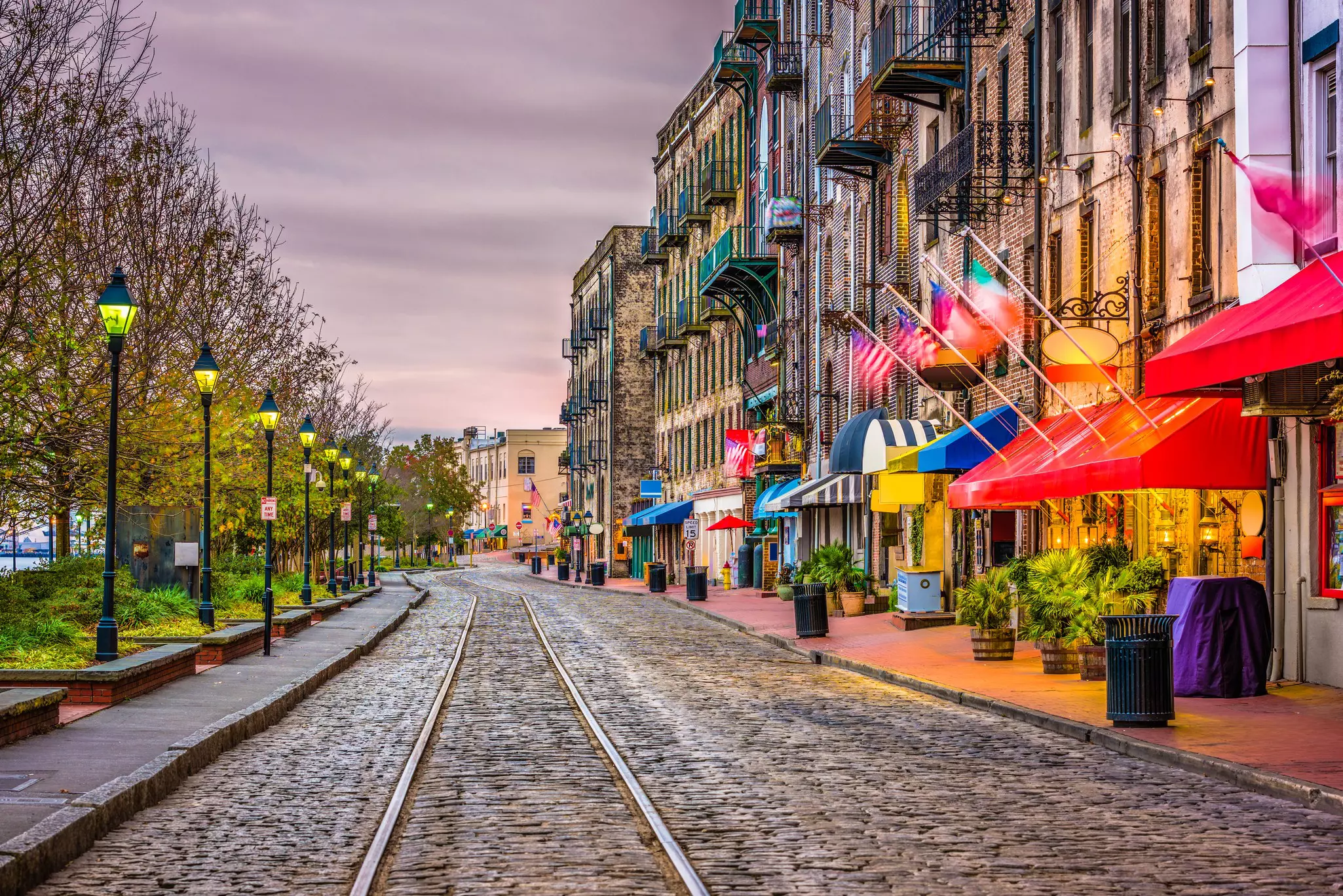 Streetcar tracks, restaurants and bars on River Street, Savannah