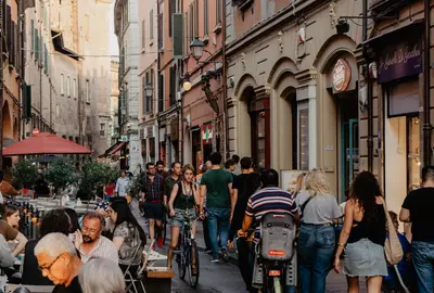 Bologna - Italien. 18. May 2022: View of Tourists and Locals dining and walking in the Heart of Bologna's old city