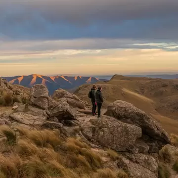 Two people standing on Cerro Uritorco, a mountain and highest peak of the Sierras Chicas chain in the northwest of the province of Cardoba, Argentina.  