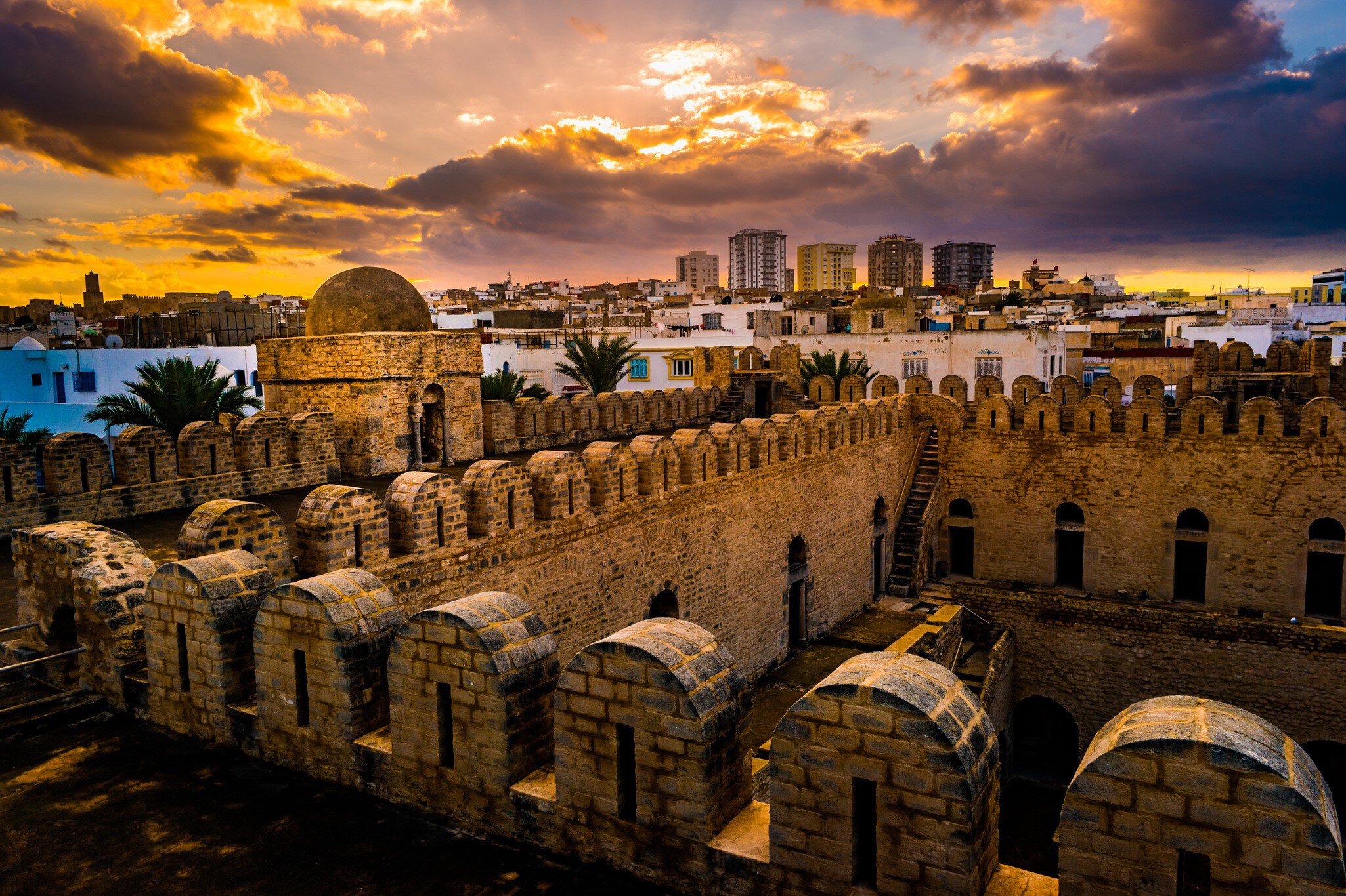 The fortress walls of the Ribat of Sousse during sunset.
562040539
islam, tower, town, stone, nobody, travel, fortified, yellow, architectural, magic, castle, history, bastion, fort, east, old, arabia, africa, obsolete, vertical, traditional, clouds, tunis, fortress, wall, tunisia, architecture, city, blue, outdoors, monastery, mediterranean, ancient, arab, fairy, build, fortification, medina, arabic, tunisian, construction, tale, muslim, exterior, landscape, kasbah, ribat, susa