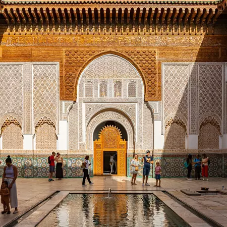 An ornate Moroccan tiled building with arches. 
