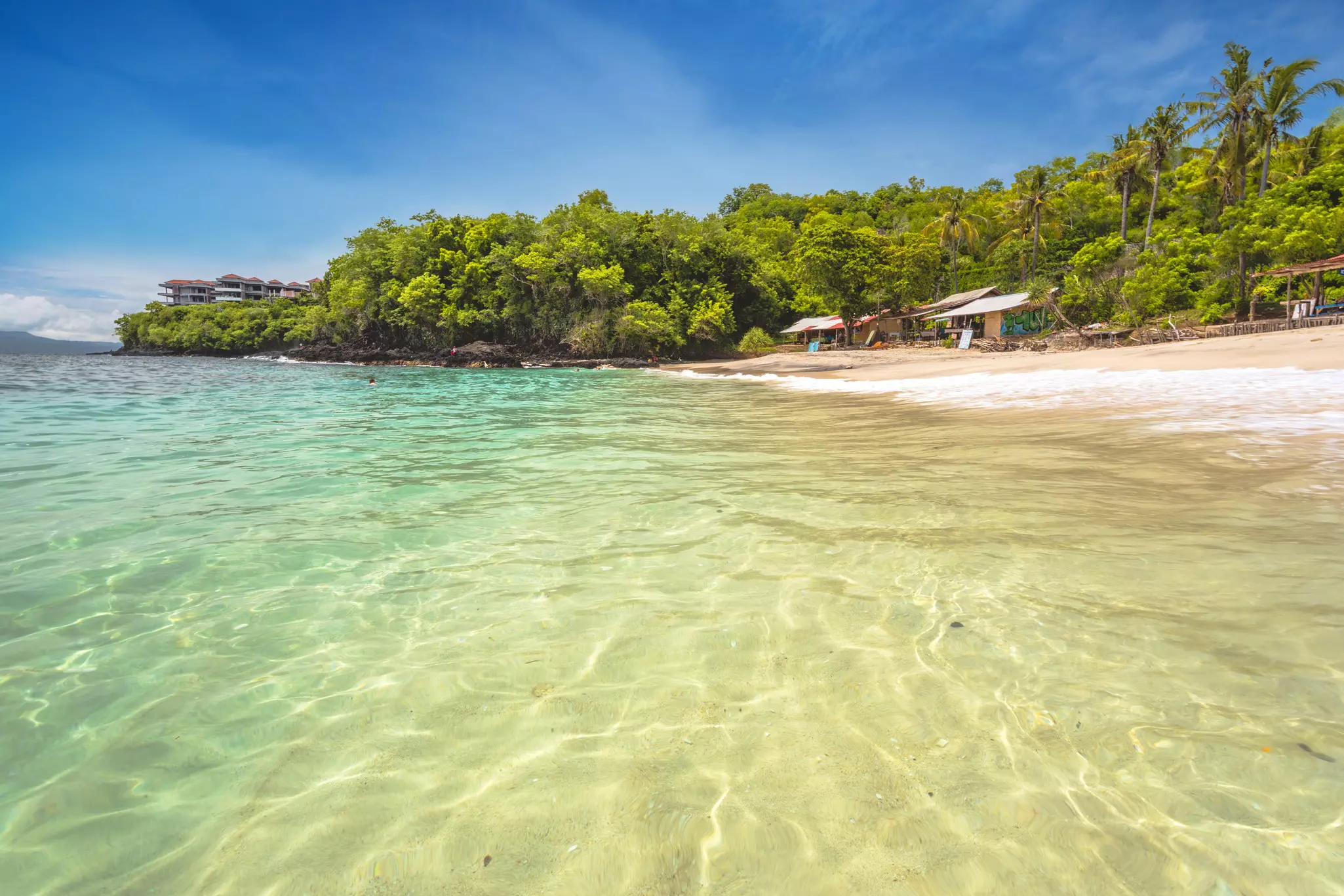 The White Sand Beach (Bias Tugel) is a popular local destination for its pristine turquoise waters. Padangbai, Karangasem, eastern Bali, Indonesia.