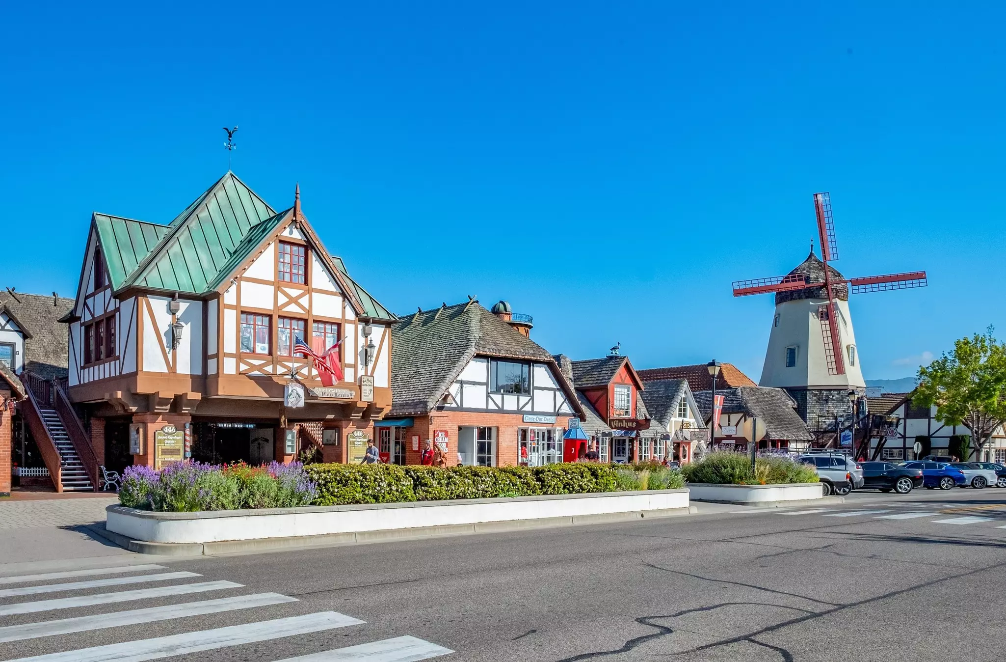Wide shot of Danish-style buildings and windmill on a sunny day.
