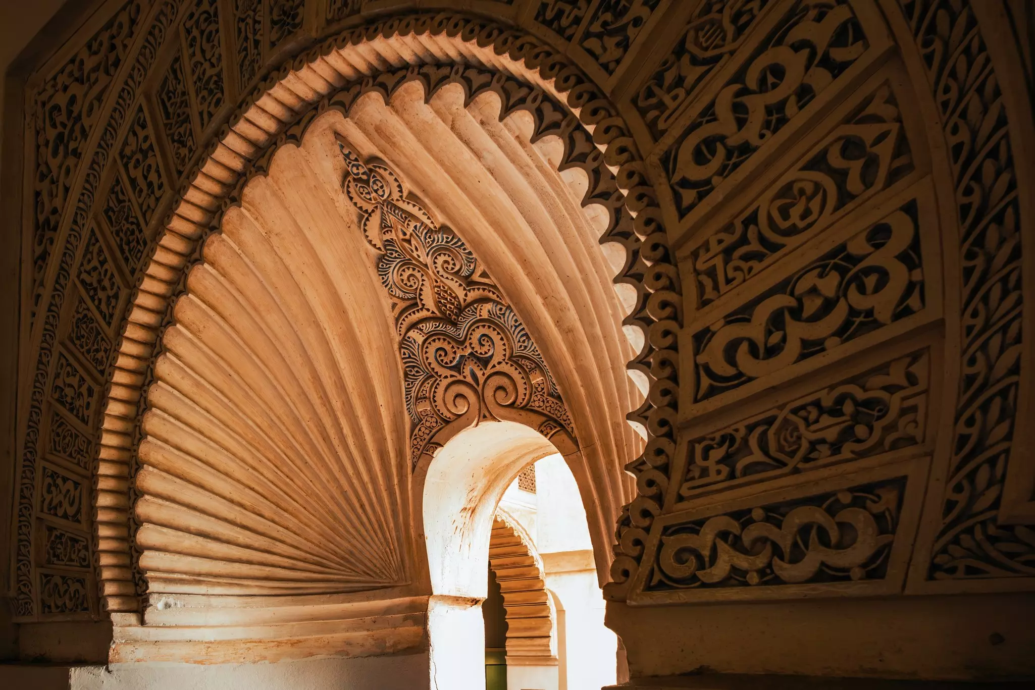 A close-up shot of ornate plaster work in the archway of a window.
