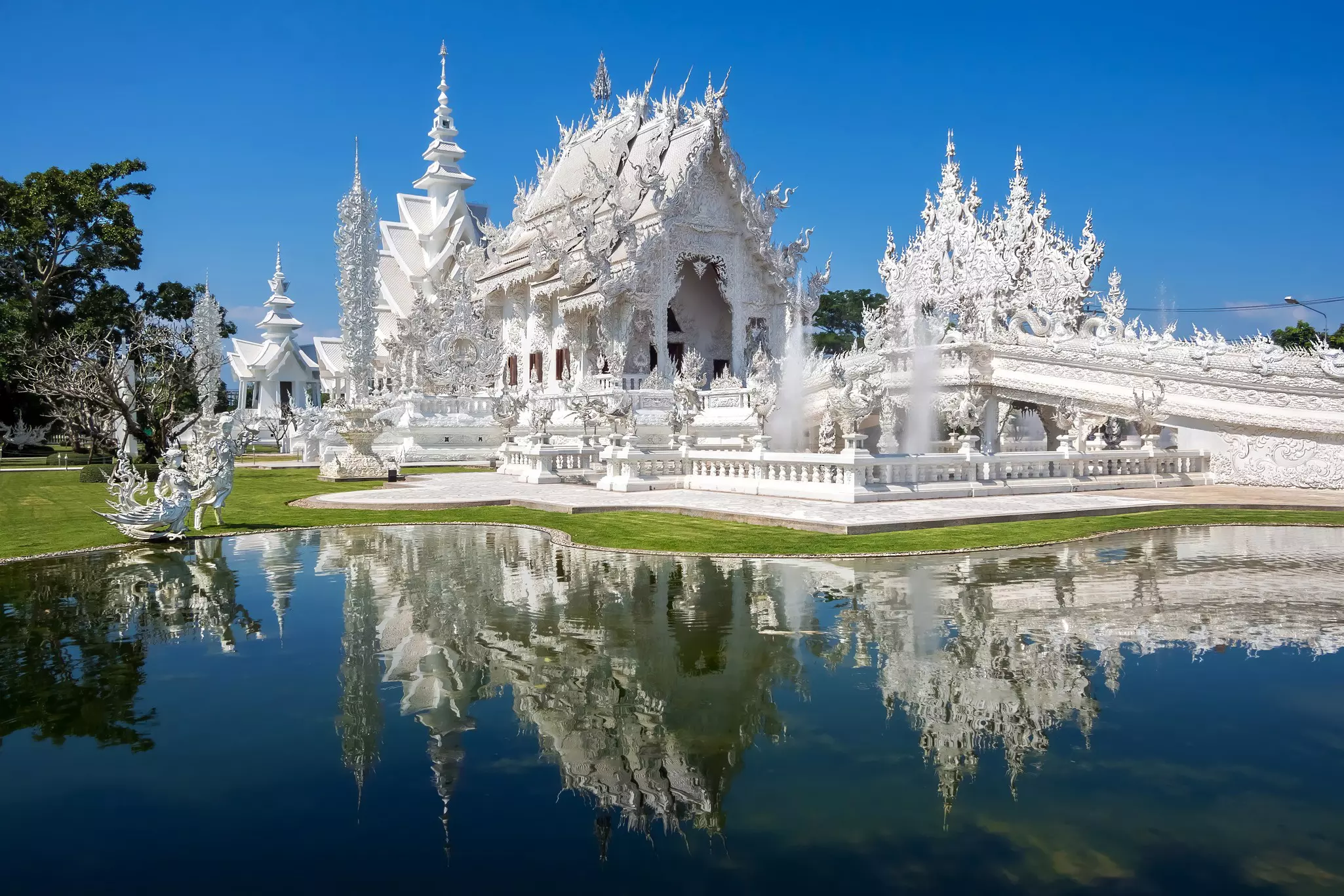 The extravagant white architecture of Wat Rong Khung in Chiang Rai, Thailand.